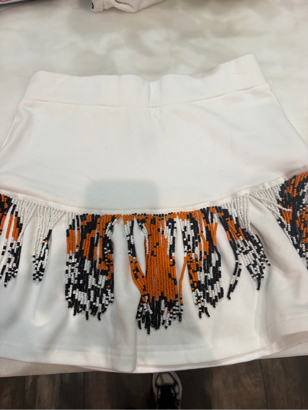 QUEEN OF SPARKLES White Mini Skirt with Orange and Black Beaded Fringe